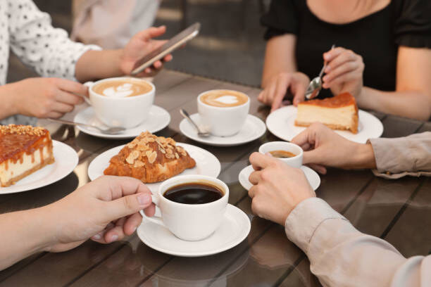 Friends sharing coffee and pastries around a table
